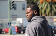 Kamani Holmes walks through his old neighborhood in "Ghost Town" West Oakland. Photo by Rachel Loyd
