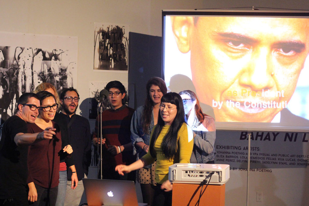 Attendees belt out karaoke classics with executive order lyrics at Pro Arts Gallery.