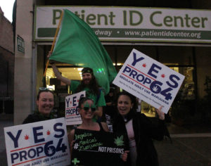 Supporters of Prop 64 gathered outside the Patient ID Center on Broadway in Downtown Oakland urging all in the street to legalize cannabis. From left to right, Lauren Vazquez, Chris Conway, Danielle Negrin and Nikki Romero. Photo by Nate Shiedlower.