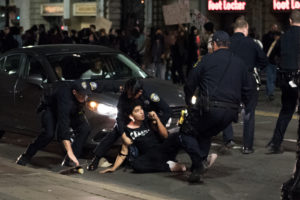 After a peaceful demonstration, marchers were setting off once more along Broadway when police officers arrested a man. Photo by Rosa Furneaux.