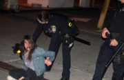 OPD officers arrest a protester in downtown Oakland. Photo by Andrew Beale.