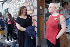 Sappho Faires and Kadie Tolliver wore buttons that Faires had made. Faires was the first person in line---she'd been waiting since 3:43pm. Photo by Ryan Lindsay.