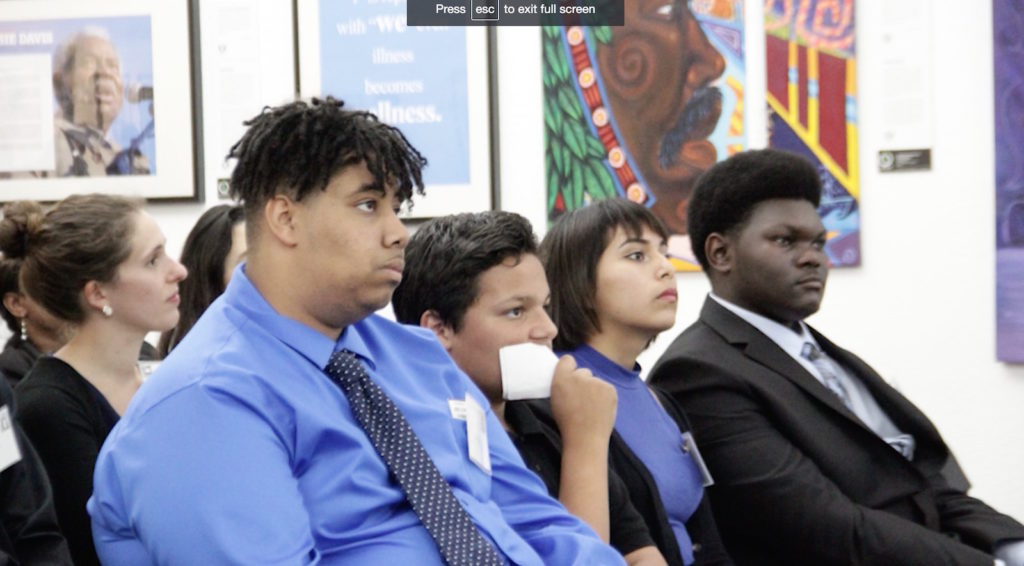Audience members watch the debate.