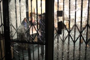 Shop keepers gather in a store hours after it was vandalized. Photo by Jacob Shea.