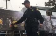 Alameda County Sheriff Gregory Ahern points to a photograph of firefighters preserving debris as evidence. Original image courtesy of the Oakland Police Department.