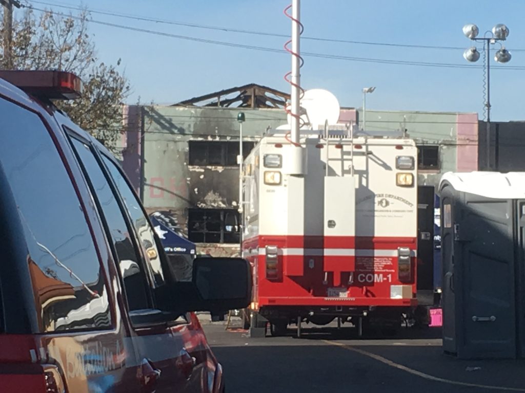 A fire department vehicle outside the warehouse, where the roof has collapsed. Photo by Sonner Kehrt.