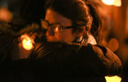 Two mourners, among the thousands present, embrace at the candlelight vigil. Photo by Khaled Sayed