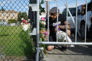 People brought flowers, balloons and candles to leave as memorials. Photo by Margaret Katcher.