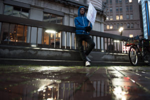 Protester Brandon Hodges, an Oakland resident, stands apart from the crowd in Frank H. Ogawa Plaza. His reason for attending the protest, he said, was "to be in solidarity with people, for what I believe is real change." Photo by Rosa Furneaux.