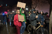 Protesters march along Broadway with signs. Photo by Rosa Furneaux.