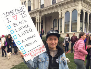 "I made the sign so grassroots movements can triple down on their commitment to eliminating systems of oppression," said Tash Nguyen. Photo by Abner Hauge.