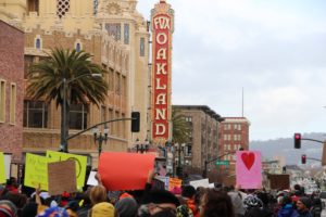 Protesters march past the Fox theater on Telegraph Ave. during Friday's presidential inauguration protests.