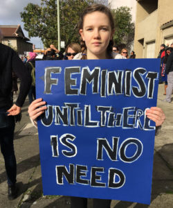 Skyline High student Olive Blaire,15, says she's marching for the social, political and economic equality of women. Photo by Rachel Loyd.