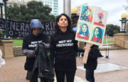 Demonstrator Yael Martinez holds a picket sign in front of Oakland City Hall, where a march is planned for noon. ”Its alarming this is where we are in 2017,” she said. Photo by Abner Hauge.