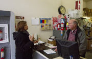 City of Oakland Economic Development Manager Aliza Gallo explains the Small Business Administration's emergency loan program to John McLeod of Acme Fire Extinguishers Company. Photograph by Abner Hauge