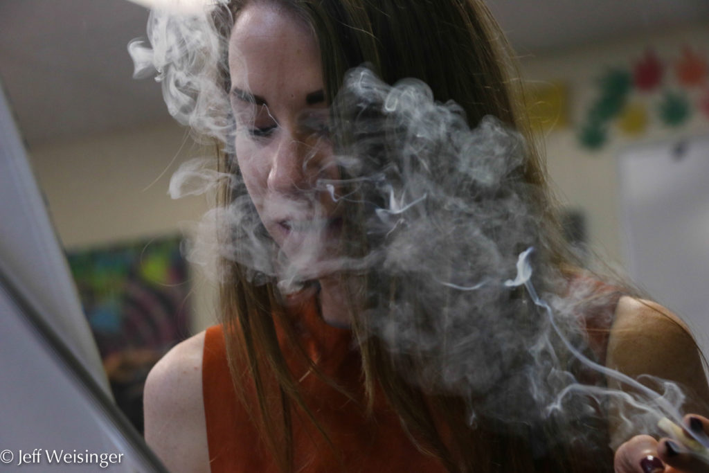 As soon as class participants arrived, they picked up a paint brush with one hand and a joint or vape pen in the other. (Photo Jeff Weisinger)