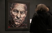 A Star Trek fan examines a painting of Captain Picard in the exhibit. (Photo Cameron Clark)