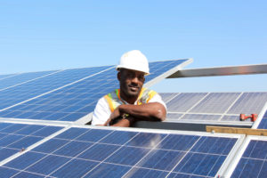 RichmondBUILD worker installing solar panels. (Photo by MCE)
