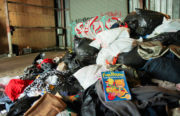 A pile of items donated to victims of the San Pablo fire sits in a warehouse in West Oakland. Photo by Abner Hauge.