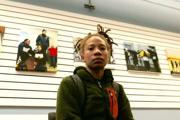 Alana Banks sits in front a photo gallery in the Fannie Lou Hamer Center. Photo by: Alexandria Fuller