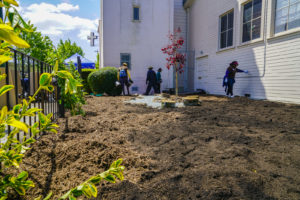 Volunteers gather at the Memorial Tabernacle Church for a lawn party to restore the church's garden on Saturday, May 6, 2017. (Yesica Prado/Oakland North)