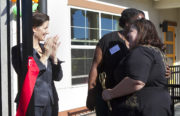 Oakland Mayor Libby Schaaf claps and looks on as Alternatives in Action ECEC Program Director Cierra Pierce and Executive Director Patricia Murillo embrace following the ribbon-cutting ceremony.