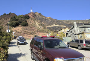 A helicopter drops fire retardant over the rock quarry on Edwards Boulevard in the Oakland Hills after a four-alarm fire broke out on Tuesday. Photo by Drew Costley.