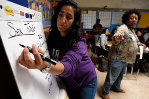 Salomeh Ghorban, takes notes as Moderator Reverend Damita Davis-Howard speaks during a meeting of residents who discussed issues facing East Oakland as part of the launch of the first annual East Oakland Congress of Neighborhoods assembly at the International Community School on International Boulevard. Photo by Lisa Hornak