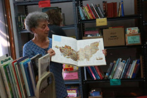 Redni Voorhies is a retired school teacher and former librarian who began volunteering in 2010. Using her expertise in books, she walked around the room, excitedly giving helpful suggestions to those selecting books.