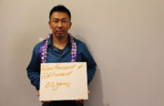 At a fundraiser for the Asian Prisoner Support Committee, Nghiep Ke Lam, the organization’s reentry coordinator, holds a sign that shows how long he was imprisoned.