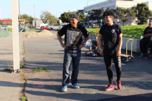 Nghiep Ke Lam (left) participates at an activity and resource fair at Madison Park in Oakland.