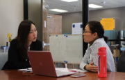 Lina Park(left) talks about a grant report with Emily Park at Asian Health Services in Oakland.
