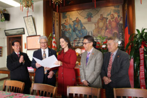 Mayor Libby Schaaf(middle) is delivering a "certificate of recognition" to Spencer Y. Chew, the president of the Loong Kong Tien Yee Association in Oakland's Chinatown.