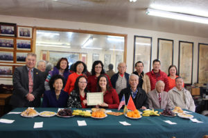 Mayor Libby Schaaf is holding a "certificate of recognition" with a member of Suey Sing Chamber of Labor Commerce in Chinatown.