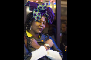 Tanefer Camara throws up an X symbol, which is flashed in Marvel's Black Panther as a symbol for Wakanda, while cosplaying Shuri, a character in the film.