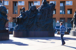 People pass by monument