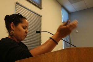 Science teacher Megan Bumpus highlights the importance of increasing teacher salary during public comment. (Photo by Mickey Capper)