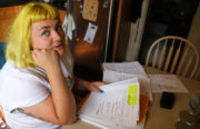 Carolyn Pulvino looks over documents her landlord filed to exempt her unit from rent control using the "substantial rehabilitation rule."