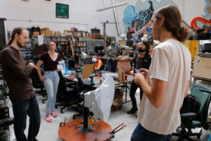 Sudo Mesh volunteers get ready to test an AirFiber radio transceiver. They hope to use it to relay a gigabit of bandwidth from Paxio's roof downtown to Temescal's Omni Commons.