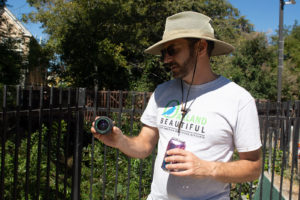 Bob Bodnar chair of Keep Oakland Beautiful shows one of the rare findings at César Chavez Park in Fruitvale