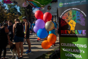 A crowd gathers by the Lake Merritt pergola for Oakland Pride's annual 5K run, led by the Oakland LGBTQ Center this year, early Sept. 8.