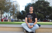 Tim Donaghy, Senior Research Specialist at Greenpeace, sits on the steps of Frank H. Ogawa Plaza in Downtown Oakland