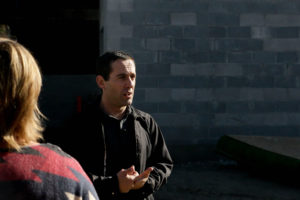 Community Foods Market CEO Brahm Ahmadi speaks to a group of residents from Oakland and neighboring cities about the progress of the grocery store's construction at a site tour on October 13.