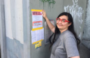 Marissa Seko, a volunteer from Socialist Feminist Caucus posting polling station details outside a homeless encampment on Sunday. Photo Courtesy of Marissa Seko.