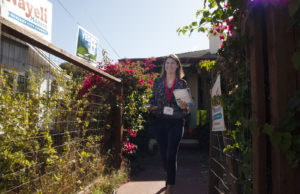 Nayeli Maxson pictured leaving her home to go knock on doors in her neighborhood, which is near the Fairfax Business District, the area around Horace Mann Elementary. Photo by Sarah Trent.