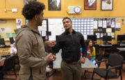 Volunteer facilitator Christian Corral (right) guides Rudsdale High School students through complicated situations involving the law.