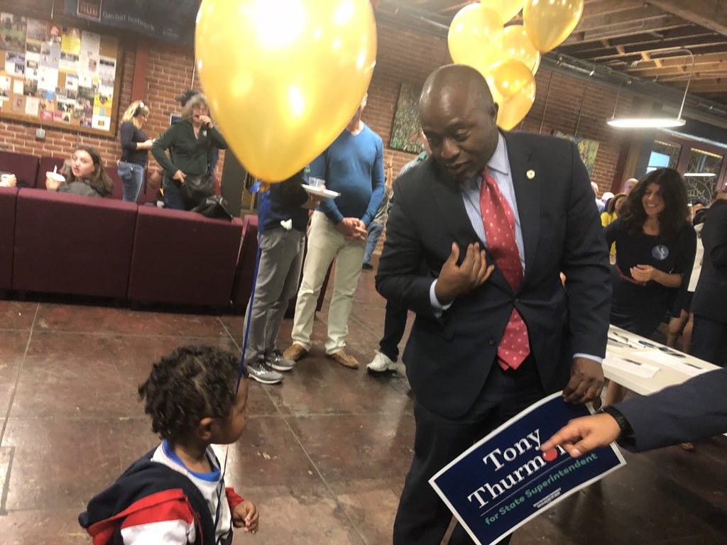 Tony Thurmond, candidate for State Superintendent for Public Instruction, arrives at his election watch party at Impact Hub, greeted by some children who had been standing by the door. Photo by Mickey Capper.