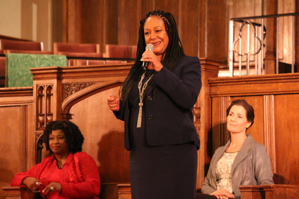 Oakland mayoral candidate Cat Brooks (center) tells the crowd gathered for a forum at First Presbyterian Church "I’m someone who loves this community deeply." Incumbent Mayor Libby Schaaf (right) and candidate Pamela Price (left) sit in silence.