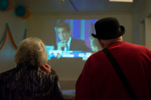 Supporters snack on quesadillas while watching results tick in on the projection of ABC News playing overhead. Photo by Rosa Tuiran Grobet.