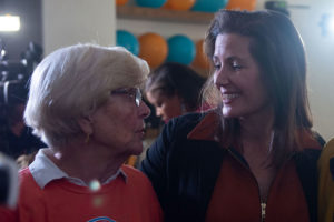 Arm around her mother, Barbara Schaaf Schock (left) Libby Schaaf (right) enjoys her Election Night watch party and reflects on the campaign. Four years ago, Schaaf says, it was a little more “civil. But, you know, this is Oakland. It’s always going to spirited.” Photo by Rosa Tuiran Grobet.